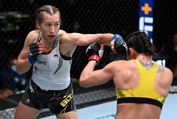 In this handout photo provided by UFC, Mandy Bohm of Germany punches Ariane Lipski of Brazil in a flyweight fight during the UFC Fight Night event at...