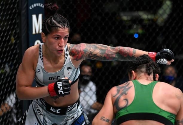 In this handout photo provided by UFC, Pannie Kianzad of Iran punches Raquel Pennington in a bantamweight fight during the UFC Fight Night event at...