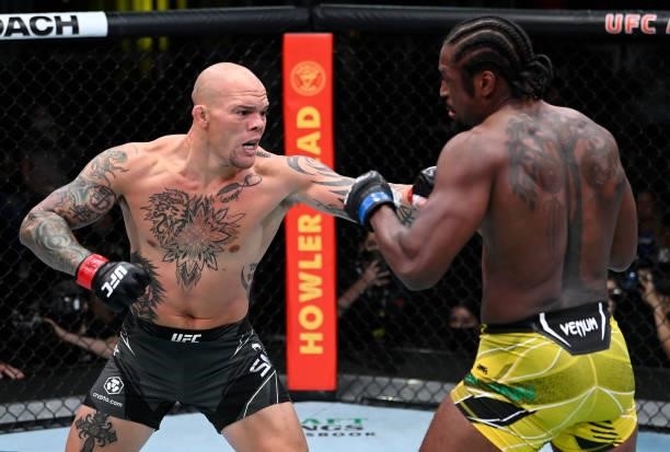 In this handout photo provided by UFC, Anthony Smith punches Ryan Spann in a light heavyweight fight during the UFC Fight Night event at UFC APEX on...