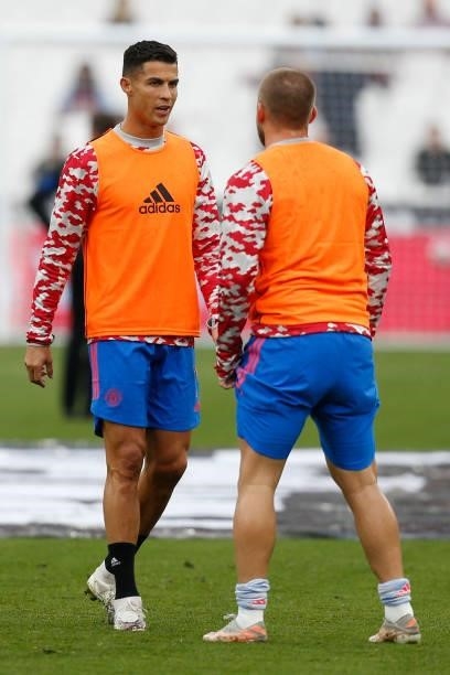 Manchester United's Portuguese striker Cristiano Ronaldo chats with Manchester United's English defender Luke Shaw as they warm up ahead of the...