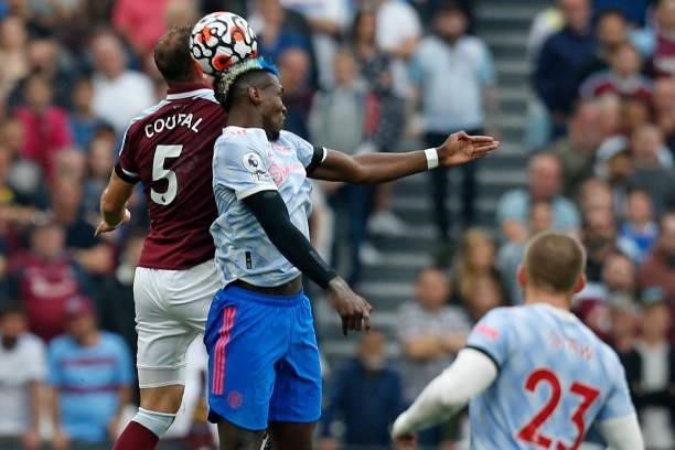 West Ham United's Czech defender Vladimir Coufal vies with Manchester United's French midfielder Paul Pogba during the English Premier League...