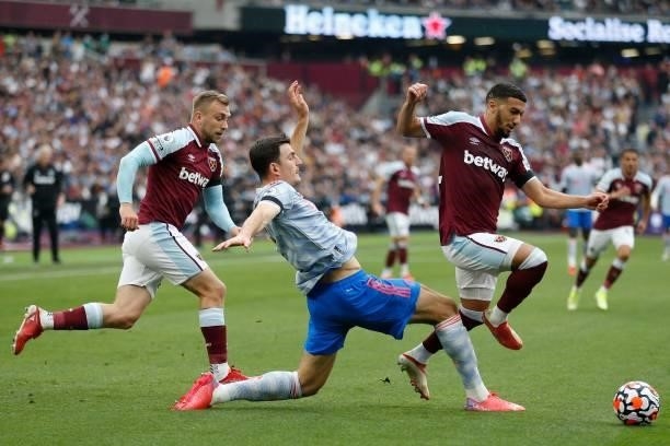 West Ham United's Algerian midfielder Said Benrahma skips past the challenge from Manchester United's English defender Harry Maguire during the...