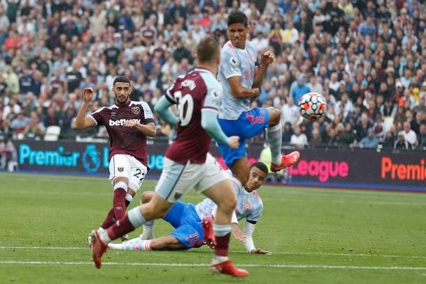 West Ham United's Algerian midfielder Said Benrahma sees his shot deflected into the goal by Manchester United's French defender Raphael Varane for...
