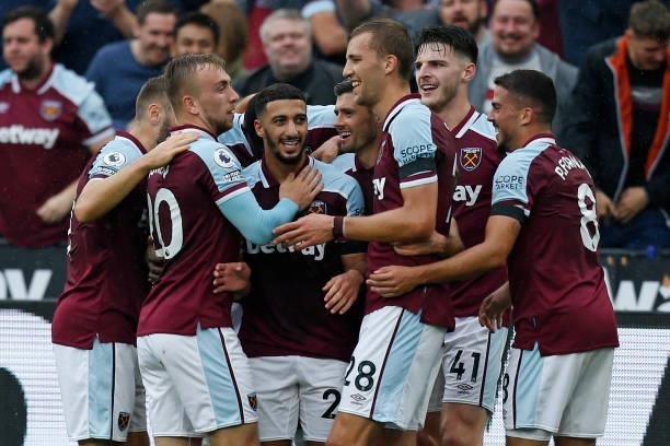 West Ham United's Algerian midfielder Said Benrahma celebrates with teammates after scoring the opening goal during the English Premier League...