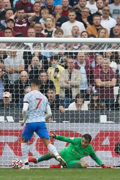Manchester United's Portuguese striker Cristiano Ronaldo scores their first goal past West Ham United's Polish goalkeeper Lukasz Fabianski during the...