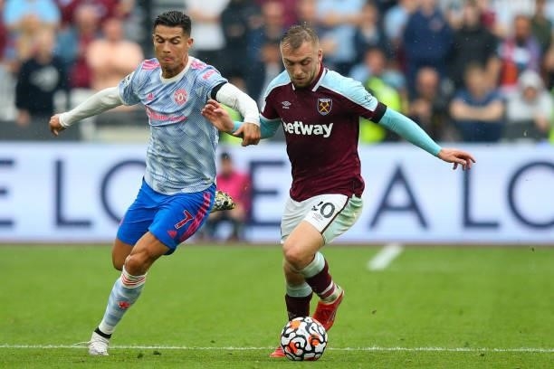 Jarrod Bowen of West Ham United holds off the challenge from Cristiano Ronaldo of Manchester United during the Premier League match between West Ham...