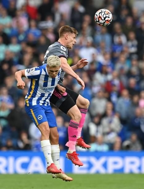 Brighton's Belgian midfielder Leandro Trossard challenges Leicester City's English midfielder Harvey Barnes during the English Premier League...