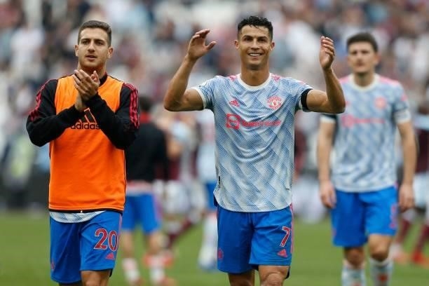 Manchester United's Portuguese defender Diogo Dalot and Manchester United's Portuguese striker Cristiano Ronaldo celebrate on the pitch after the...
