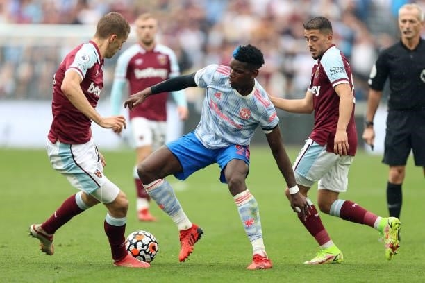 Paul Pogba of Man Utd is surrounded by Tomas Soucek and Pablo Fornals of West Ham during the Premier League match between West Ham United and...