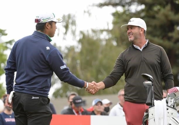 Hideki Matsuyama and Scott Piercy shake hands on the first tee during the third round of the Fortinet Championship at Silverado Resort and Spa North...