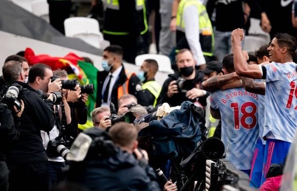 Jesse Lingard of Manchester United is mobbed by his team-mates in front of photographers after scoring the winning goal during the Premier League...