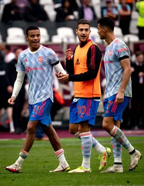 Diogo Dalot of Manchester United walks off with his team-mates Mason Greenwood and Cristiano Ronaldo at the end of the Premier League match between...