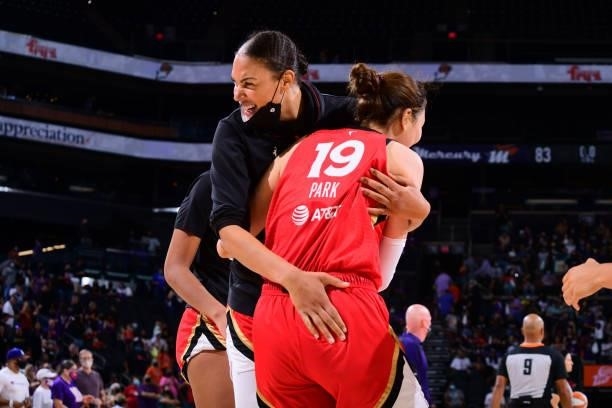 Liz Cambage and JiSu Park of the Las Vegas Aces celebrate during the game against the Phoenix Mercury on September 19, 2021 at Footprint Center in...