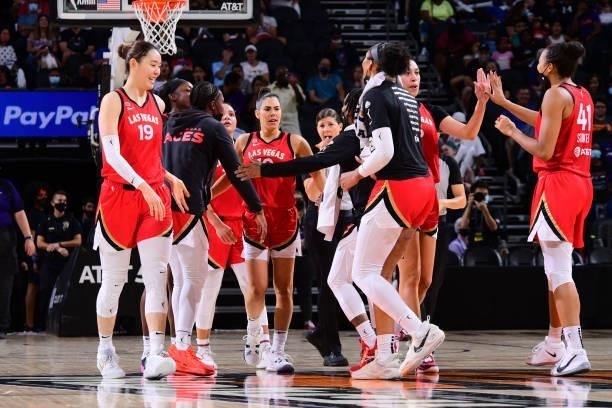 Kelsey Plum of the Las Vegas Aces hi-fives teammates during the game against the Phoenix Mercury on September 19, 2021 at Footprint Center in...