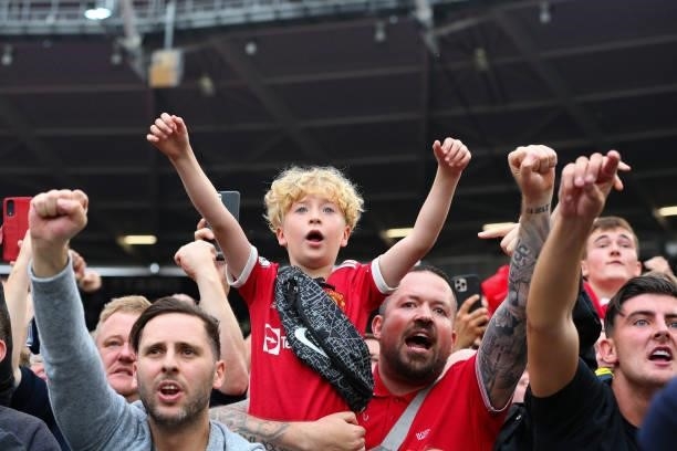 Manchester United fans celebrate after the Premier League match between West Ham United and Manchester United at London Stadium on September 19, 2021...