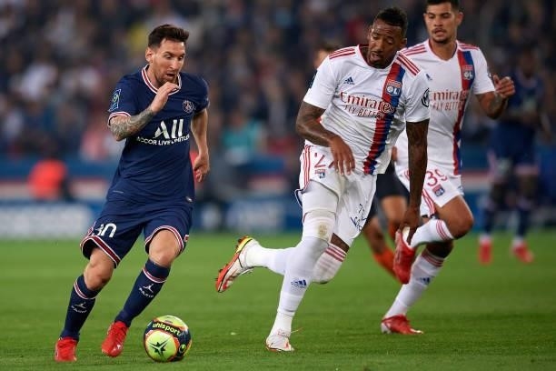 Leo Messi of PSG and Jerome Boateng of Olympique Lyonnais compete for the ball during the Ligue 1 Uber Eats match between Paris Saint Germain and...