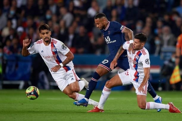 Neymar of PSG and Nathan Bitumazala and Lucas Paqueta of Olympique Lyonnais compete for the ball during the Ligue 1 Uber Eats match between Paris...