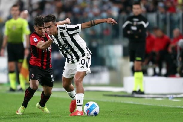 Paulo Dybala of Juventus FC and Brahim Diaz of AC Milan battle for the ball during the Serie A match between Juventus and AC Milan at Allianz Stadium...