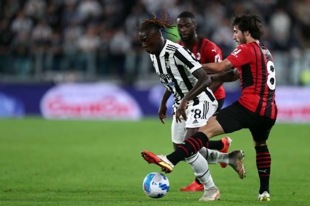 Moise Kean of Juventus FC and Sandro Tonali of AC Milan battle for the ball during the Serie A match between Juventus and AC Milan at Allianz Stadium...