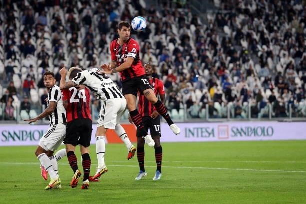 Alessio Romagnoli of AC Milan and Leonardo Bonucci of Juventus FC battle for the ball during the Serie A match between Juventus and AC Milan at...