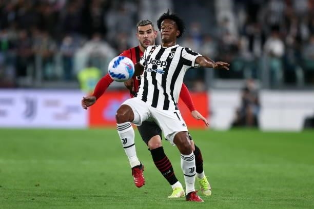 Juan Cuadrado of Juventus FC and Theo Hernandez of AC Milan battle for the ball during the Serie A match between Juventus and AC Milan at Allianz...