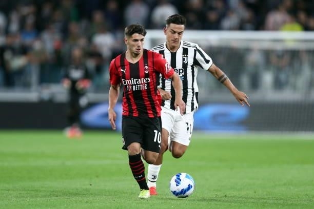 Brahim Diaz of AC Milan and Paulo Dybala of Juventus FC battle for the ball during the Serie A match between Juventus and AC Milan at Allianz Stadium...