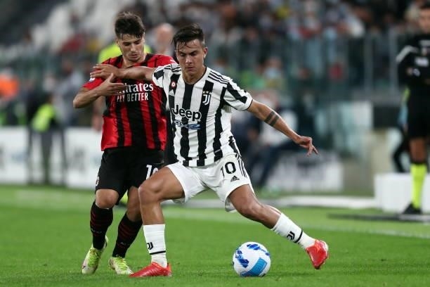 Paulo Dybala of Juventus FC and Brahim Diaz of AC Milan battle for the ball during the Serie A match between Juventus and AC Milan at Allianz Stadium...