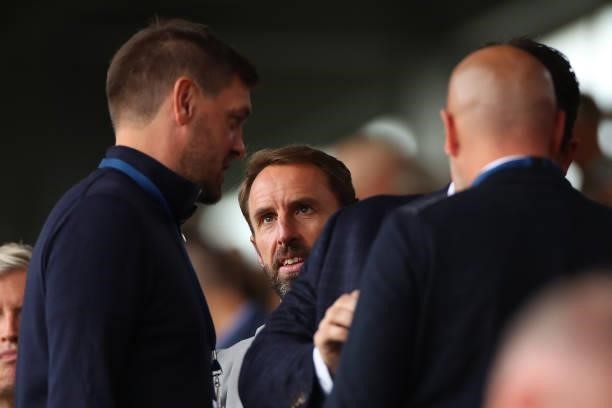 Gareth Southgate the head coach / manager of England talks to Jonathan Woodgate during the Premier League match between Burnley and Arsenal at Turf...