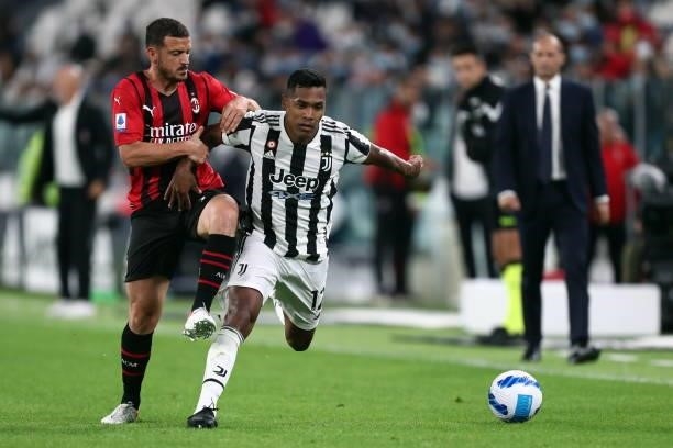 Alex Sandro of Juventus FC and Alessandro Florenzi of AC Milan battle for the ball during the Serie A match between Juventus and AC Milan at Allianz...