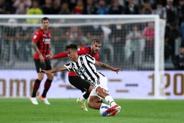 Theo Hernandez of AC Milan and Paulo Dybala of Juventus FC battle for the ball during the Serie A match between Juventus and AC Milan at Allianz...
