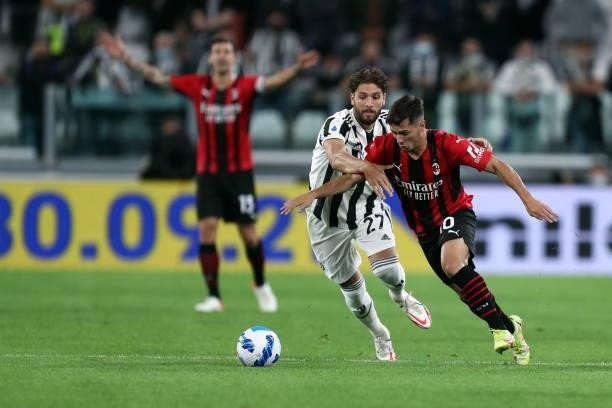 Manuel Locatelli of Juventus FC and Brahim Diaz of AC Milan battle for the ball during the Serie A match between Juventus and AC Milan at Allianz...