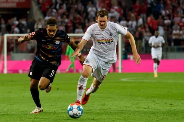 Yussuf Poulsen of RB Leipzig and Luca Kilian of 1. FC Koeln battle for the ball during the Bundesliga match between 1. FC Koeln and RB Leipzig at...