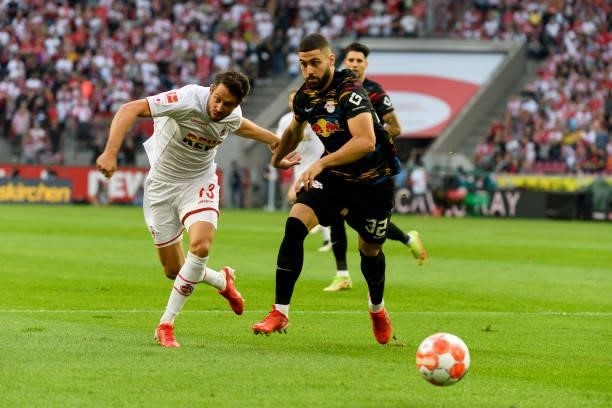 Mark Uth of 1. FC Koeln and Josko Gvardiol of RB Leipzig battle for the ball during the Bundesliga match between 1. FC Koeln and RB Leipzig at...