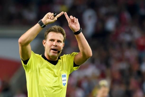 Referee Felix Brych gestures during the Bundesliga match between 1. FC Koeln and RB Leipzig at RheinEnergieStadion on September 18, 2021 in Cologne,...