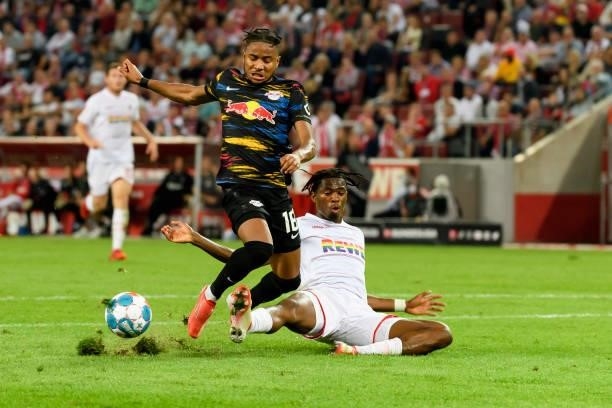 Christopher Nkunku of RB Leipzig and Kingsley Ehizibue of 1. FC Koeln battle for the ball during the Bundesliga match between 1. FC Koeln and RB...