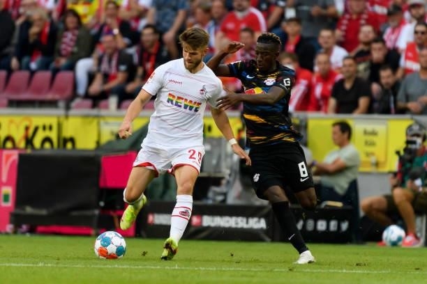 Jan Thielmann of 1. FC Koeln and Amadou Haidara of RB Leipzig battle for the ball during the Bundesliga match between 1. FC Koeln and RB Leipzig at...