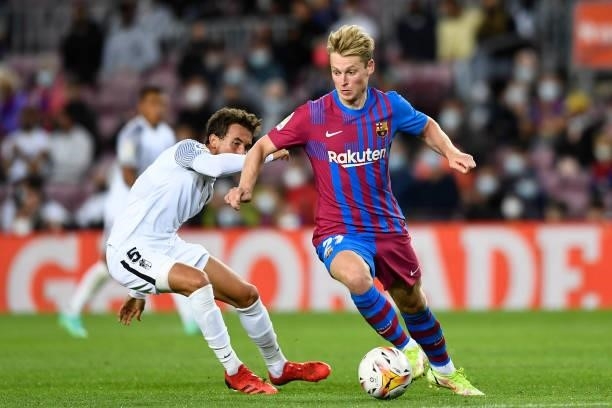 Frenkie de Jong of Barcelona and Luis Milla of Granada compete for the ball during the La Liga Santander match between FC Barcelona and Granada CF at...