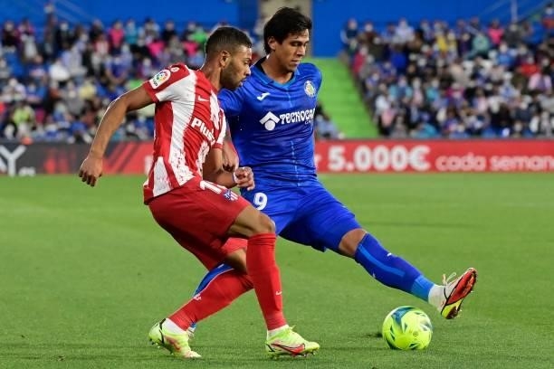Atletico Madrid's Brazilian defender Renan Lodi vies for the ball with Getafe's Mexican forward Jose Juan Macias on during the Spanish League...