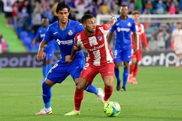 Atletico Madrid's Brazilian defender Renan Lodi vies for the ball with Getafe's Mexican forward Jose Juan Macias on during the Spanish League...
