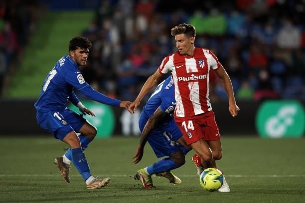 Marcos Llorente of Atletico Madrid and Carlos Aleña of Getafe compete for the ball during the La Liga Santander match between Getafe CF and Club...