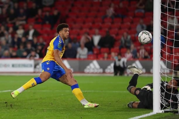 Che Adams of Southampton has a shot on goal saved by goalkeeper Wes Foderingham of Sheffield United during the Carabao Cup Third Round match between...