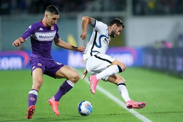 Hakan Calhanoglu of FC Internazionale and Nikola Milenkovic of ACF Fiorentina compete for the ball during the Serie A match between ACF Fiorentina...