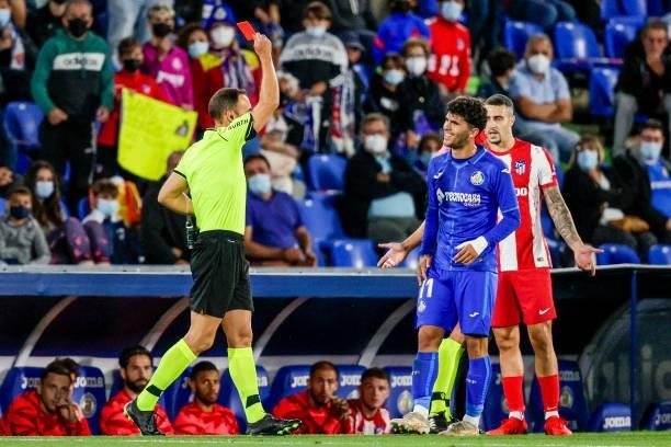 Referee Guillermo Cuadra Fernandez show the red card to Carles Alena of Getafe CF during the La Liga Santander match between Getafe v Atletico Madrid...