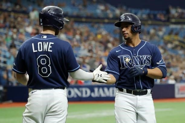 Francisco Mejia of the Tampa Bay Rays celebrates with teammate Brandon Lowe after scoring during the game between the Toronto Blue Jays and the Tampa...