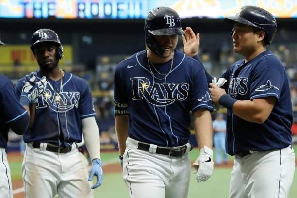 Austin Meadows celebrates with teammate Ji-Man Choi of the Tampa Bay Rays after hitting a three run home run during the game between the Toronto Blue...