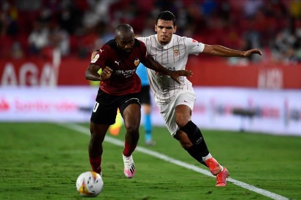 Dimitri Foulquier of Valencia and Karim Rekik of Sevilla compete for the ball during the La Liga Santander match between Sevilla FC and Valencia CF...