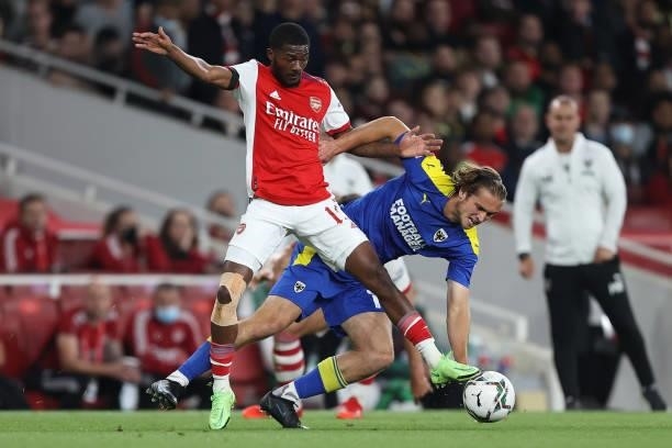 Ainsley Maitland-Niles of Arsenal and Aaron Pressley of AFC Wimbledon during the Carabao Cup Third Round match between Arsenal and AFC Wimbledon at...