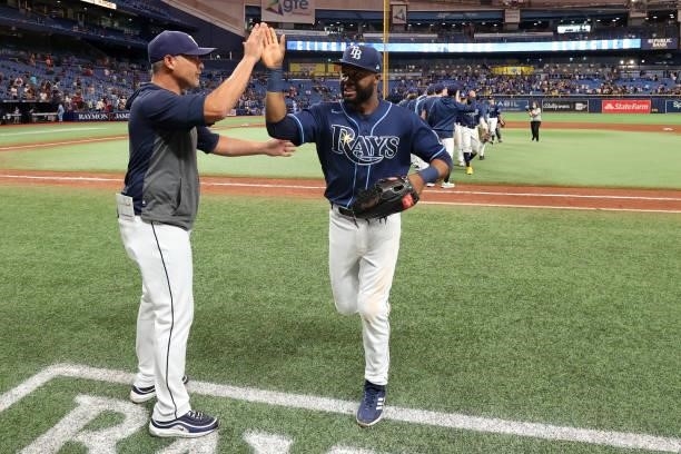 Manager Kevin Cash of the Tampa Bay Rays celebrates with Manuel Margot after defeating the Toronto Blue Jays at Tropicana Field on Wednesday,...