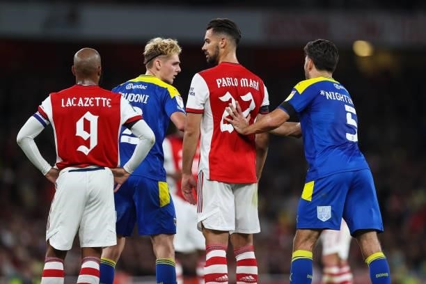 Alexandre Lacazette of Arsenal, Jack Rudoni of AFC Wimbledon, Pablo Mari of Arsenal and Will Nightingale of AFC Wimbledon during the Carabao Cup...
