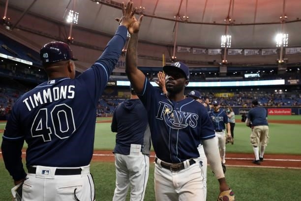 First base coach Ozzie Timmons of the Tampa Bay Rays celebrates with Randy Arozarena after defeating the Toronto Blue Jays at Tropicana Field on...